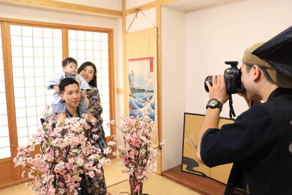 攝影師正在專業拍攝家庭照,背景是充滿日式氛圍的攝影棚,營造典雅畫面。
